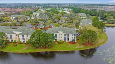 an aerial view of a house on an island in the water at 8805 Dunes Court Unit 5-202 in Kissimmee