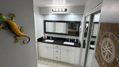 a bathroom with a sink and a large mirror at Perfecto Mundo 1, Orlando Area 5BR-2BA Outdoor Pool, Ping Pong, Billiard in Orlando