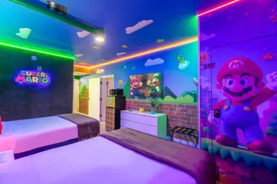 a bedroom with a mickey mouse room with purple lights at Modern Unit w Themed Room, Full Kitchen and Prime Location in Orlando
