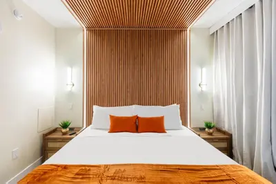 a bedroom with a large bed with two orange pillows at Modern Unit w Themed Room, Full Kitchen and Prime Location in Orlando