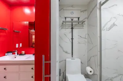 a red bathroom with a toilet and a sink at Wizard Themed Suite near Universal and Epic in Orlando