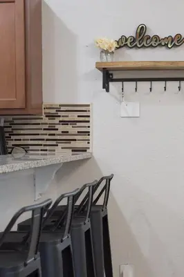 a group of chairs sitting on a counter in a kitchen at Jacuzzi and Games Close to Dwtn Disney and Parks in Orlando