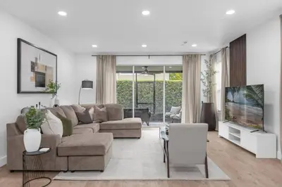 a living room with a couch and a tv at Modern Winter Park Townhome in Prime Location in Orlando