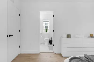 a white bathroom with white walls and white cabinets at Modern Winter Park Townhome in Prime Location in Orlando