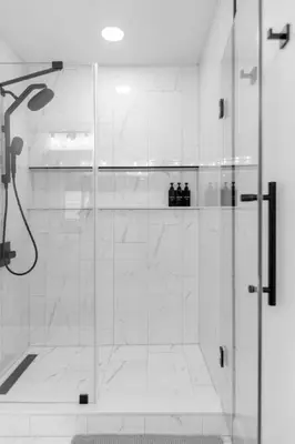 a shower with a glass door in a bathroom at Modern Winter Park Townhome in Prime Location in Orlando