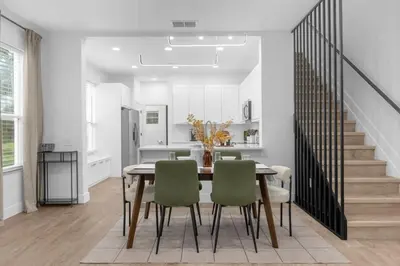 a kitchen and dining room with a table and chairs at Modern Winter Park Townhome in Prime Location in Orlando