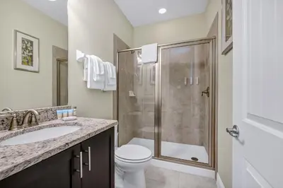 a bathroom with a shower and a toilet and a sink at Home With Theme Room, Private Pool & Game Room Near Disney With Waterpark And Resort Access At Encore Resort Reunion - 471La in Orlando