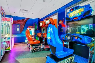 a childs room with a video game arcade at Home With Theme Room, Private Pool & Game Room Near Disney With Waterpark And Resort Access At Encore Resort Reunion - 471La in Orlando