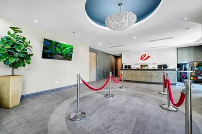 a lobby with red ribbon barriers and a potted plant at Home With Theme Room, Private Pool & Game Room Near Disney With Waterpark And Resort Access At Encore Resort Reunion - 471La in Orlando