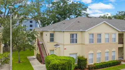 a house with a staircase in front of it at 2730 Club Cortile Circle Apt. B in Kissimmee