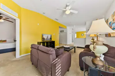 a living room with a couch and a table at 2730 Club Cortile Circle Apt. B in Kissimmee