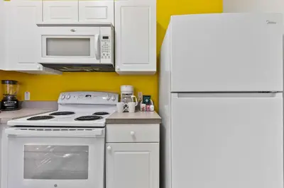 a kitchen with white appliances and a white refrigerator at 2730 Club Cortile Circle Apt. B in Kissimmee