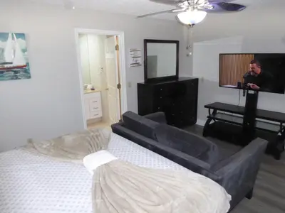 a man taking a picture of a living room at Perfecto Mundo 7, Orlando Area 6BR-2MB-3BR Indoor Pool, Ping Pong, Jacuzzi, Disney in Orlando