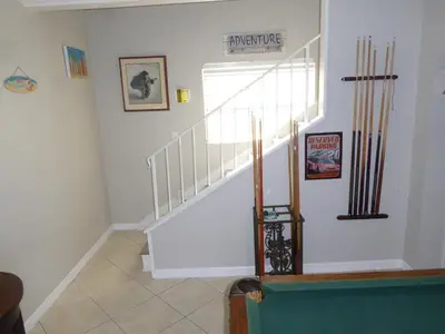 a staircase with white railings in a room at Perfecto Mundo 7, Orlando Area 6BR-2MB-3BR Indoor Pool, Ping Pong, Jacuzzi, Disney in Orlando