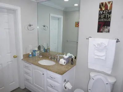 a bathroom with a sink and a toilet and a mirror at Perfecto Mundo 7, Orlando Area 6BR-2MB-3BR Indoor Pool, Ping Pong, Jacuzzi, Disney in Orlando
