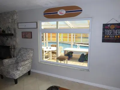 a room with a window with a surfboard on the wall at Perfecto Mundo 7, Orlando Area 6BR-2MB-3BR Indoor Pool, Ping Pong, Jacuzzi, Disney in Orlando