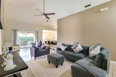 a living room with a couch and a table at Peaceful Clermont Gem with Pool, 9 Mi to Disney! in Orlando