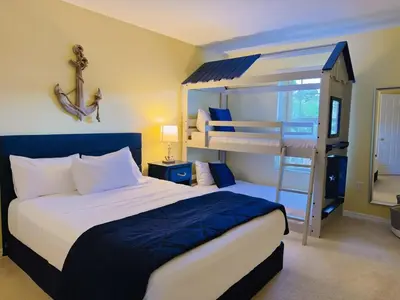 a bedroom with a bed and bunk beds at Luxury Family Villa with Pool Near Disney Parks in Kissimmee