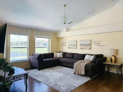 a living room with a couch and a table at Luxury Family Villa with Pool Near Disney Parks in Kissimmee