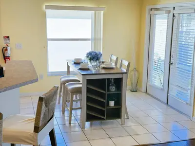 a kitchen with a table and chairs in a room at Luxury Family Villa with Pool Near Disney Parks in Kissimmee