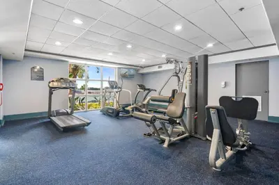 a gym with treadmills and exercise equipment in a room at 13415 Blue Heron Beach Dr 1-708 in Orlando
