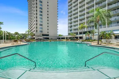 a large swimming pool with two tall buildings at 13415 Blue Heron Beach Dr 1-708 in Orlando
