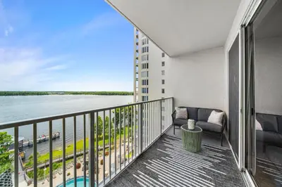 a balcony with a couch and a view of the water at 13415 Blue Heron Beach Dr 1-708 in Orlando