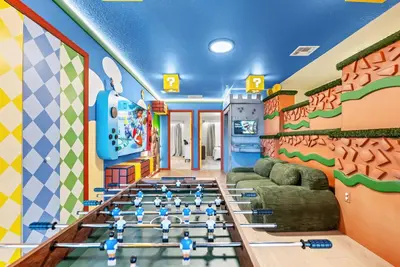 a room with a gym with people on the floor at Brand New 05 Bedrooms At Windsor Cay in Orlando