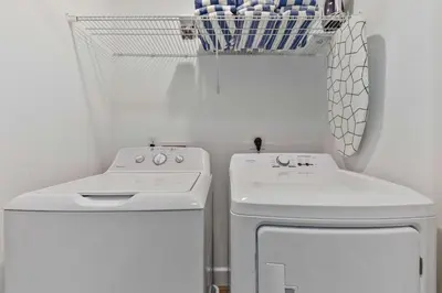 a white laundry room with a washer and dryer at 4461 Summer Flowers Pl in Kissimmee