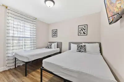 a bedroom with two beds and a window at 4461 Summer Flowers Pl in Kissimmee