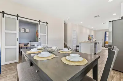 a dining room with a table with dishes on it at 4461 Summer Flowers Pl in Kissimmee