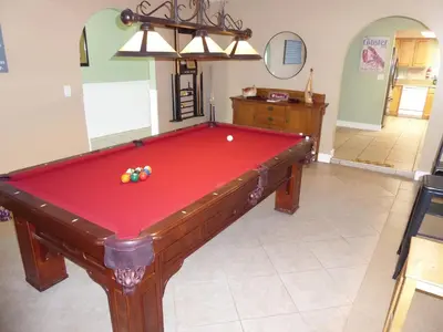 a red pool table in a living room at Perfecto Mundo 6, Orlando Area 4BR-2MB-3Bath Huge Pool, Ping Pong, Billiard, Disney Universal in Orlando