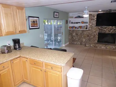 a kitchen with a counter and a living room at Perfecto Mundo 6, Orlando Area 4BR-2MB-3Bath Huge Pool, Ping Pong, Billiard, Disney Universal in Orlando