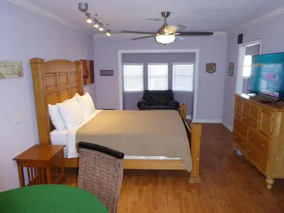 a bedroom with a bed and a desk and a television at Perfecto Mundo 6, Orlando Area 4BR-2MB-3Bath Huge Pool, Ping Pong, Billiard, Disney Universal in Orlando