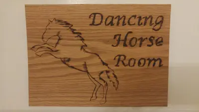 a wood sign with a drawing of a horse room at Kapp and Kappy Bed & Breakfast in Kissimmee