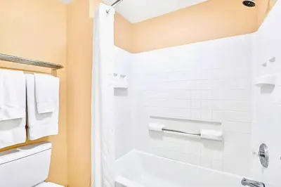 a bathroom with a white tub and a toilet at Spacious Suite close to Disney w Pool Hot Tub Arcade in Orlando