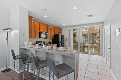 a kitchen with a bar with stools in it at Apartamento 3 Quartos no Vista Cay Resort in Orlando
