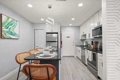 a kitchen with a table and chairs in it at Modern Escape Near Lake Eola and Downtown Orlando in Orlando