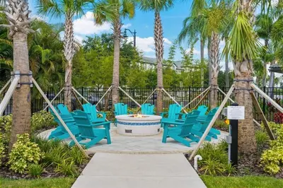 a group of blue chairs and palm trees at Townhouse Moderna no Vista Cay in Orlando