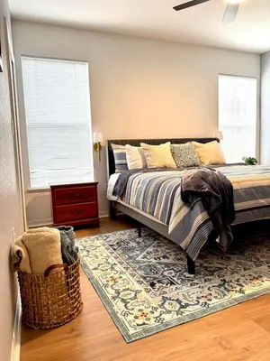 a bedroom with a bed and a rug at Wonderful apt remodeled in November near Disney in Kissimmee
