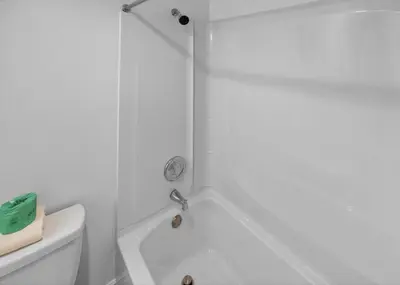 a white bathroom with a tub and a toilet at 6165 CD Unit 3603 - Enclave at Orlando Condo in Orlando