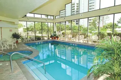 a large swimming pool in a building with windows at 6165 CD Unit 3603 - Enclave at Orlando Condo in Orlando