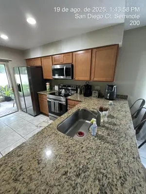 a kitchen with a sink and a counter top at Maxx Maximum Comfort LLC in Orlando