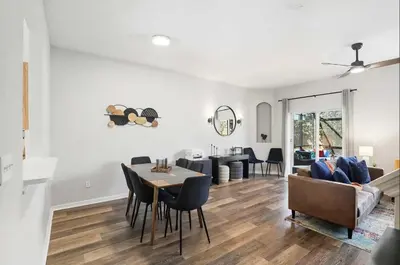 a kitchen and living room with a table and chairs at Park Hopper Paradise At Regal Oaks in Orlando