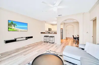 a living room with a couch and a table at Family Fun Condo Pool and Sauna near Disney in Orlando