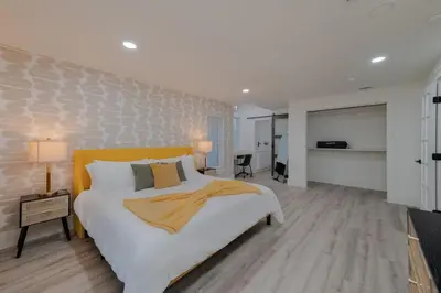 a bedroom with a large white bed and a room at Entire Home with Pool, Ping Pong Table and Arcade games in Kissimmee