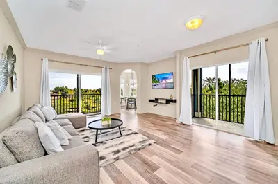 a living room with a couch and a table at Upstay Pet Friendly Condo 6 Minutes from Disney in Orlando