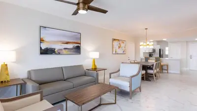 a living room with a couch and a dining room at Westgate Town Center Resort in Orlando
