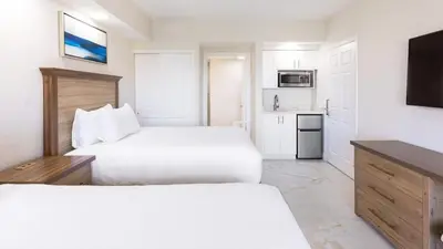 a hotel room with two beds and a kitchen at Westgate Town Center Resort in Orlando