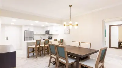 a dining room and kitchen with a table and chairs at Westgate Town Center Resort in Orlando